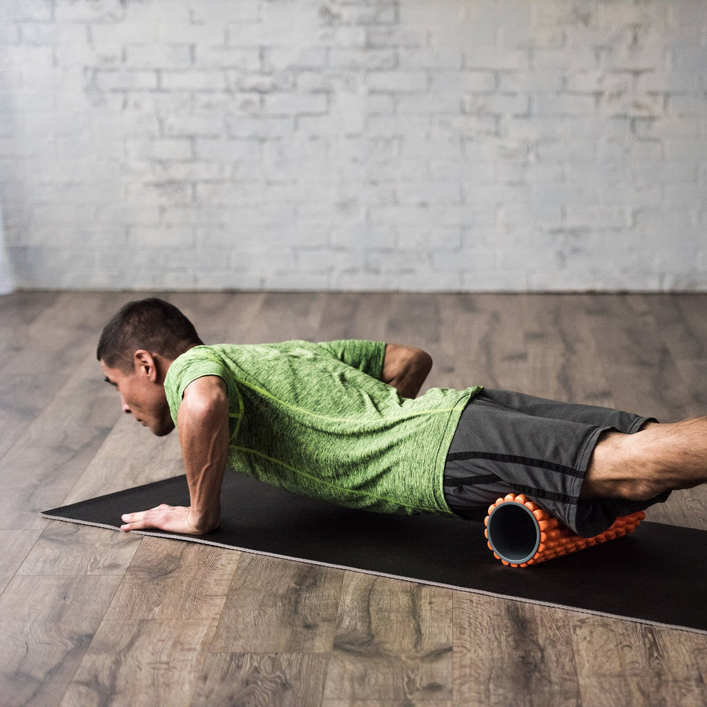 Restore Deep Tissue Foam Roller being used to roll out the legs