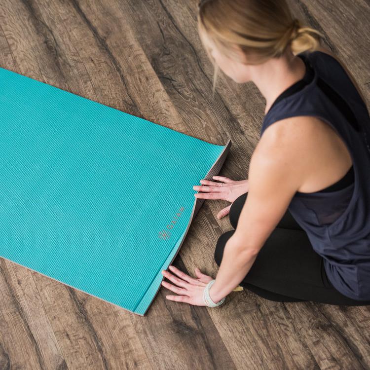 Viridian Blue Easy-Roll Yoga Mat about to be rolled up