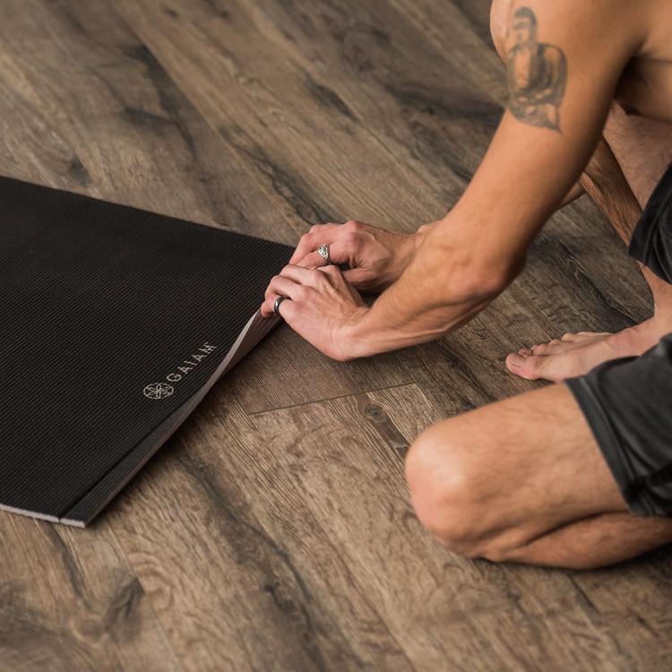 Black Easy-Roll Yoga Mat being rolled up