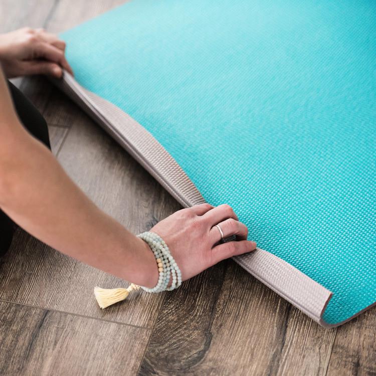 Viridian Blue Easy-Roll Yoga Mat being rolled up